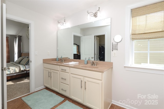 10217 Falling Leaf Dr, Concord, NC 28027 - bathroom featuring ensuite bath, double vanity, and baseboards