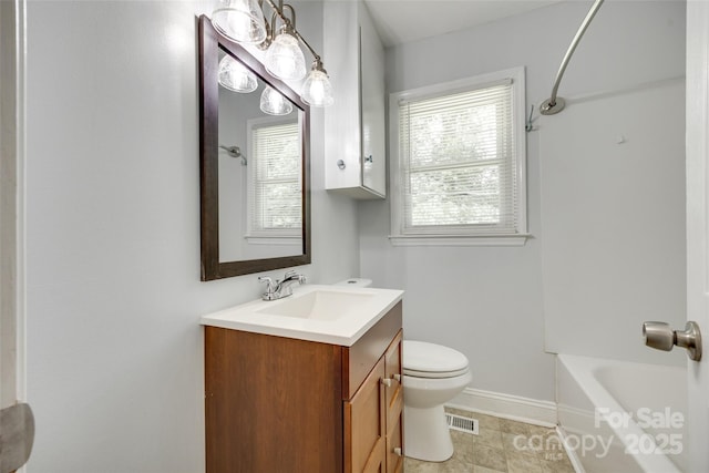 bathroom with toilet, vanity, baseboards, and bathing tub / shower combination