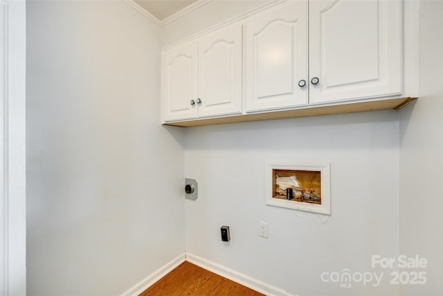 laundry area with washer hookup, cabinet space, electric dryer hookup, baseboards, and wood finished floors