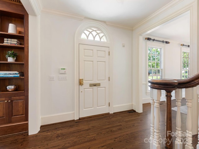 entrance foyer featuring dark wood-style flooring, crown molding, and baseboards