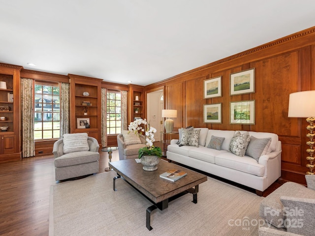 living area with wood finished floors and wood walls