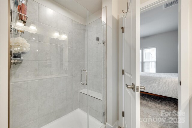 ensuite bathroom featuring a stall shower