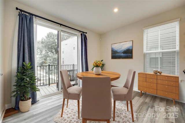 dining area featuring light wood-style floors, baseboards, and recessed lighting