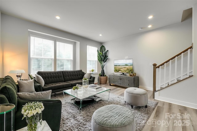 living room with wood finished floors, recessed lighting, stairs, and baseboards