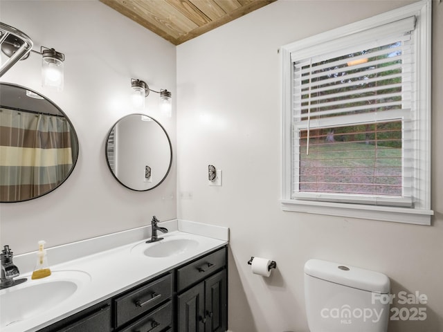 full bathroom featuring double vanity, wooden ceiling, toilet, and a sink