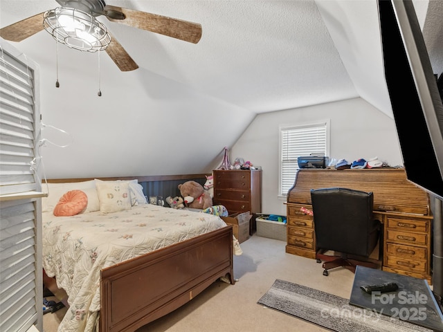 carpeted bedroom with a ceiling fan, a textured ceiling, and vaulted ceiling