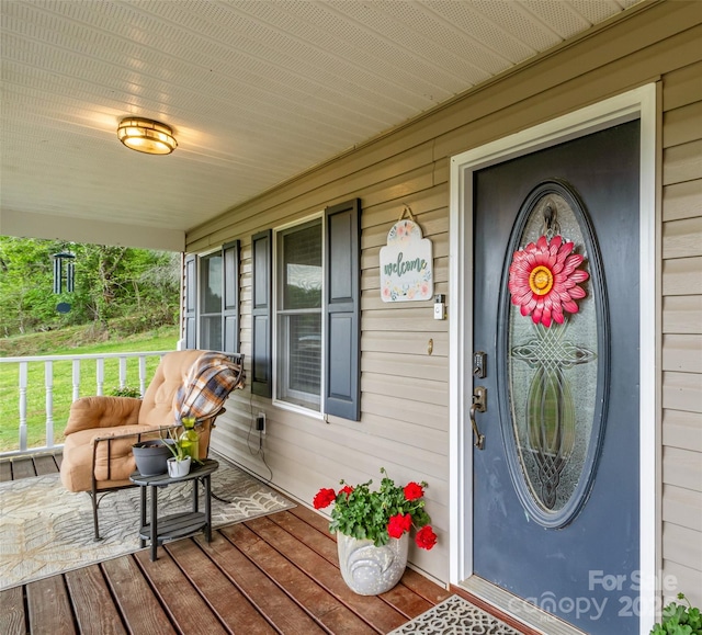 view of exterior entry featuring a porch
