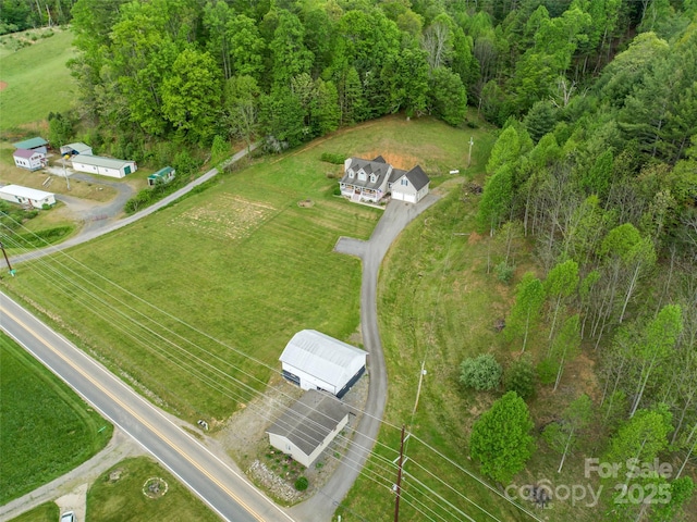bird's eye view featuring a wooded view