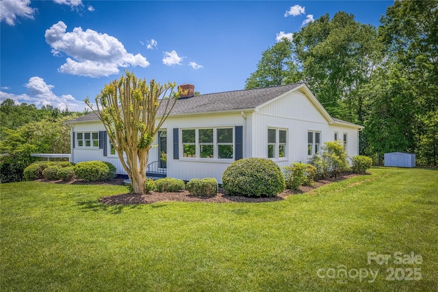 417 Mountain View Ave SE, Valdese, NC 28690 - view of side of home with a storage shed, a chimney, a yard, and an outdoor structure