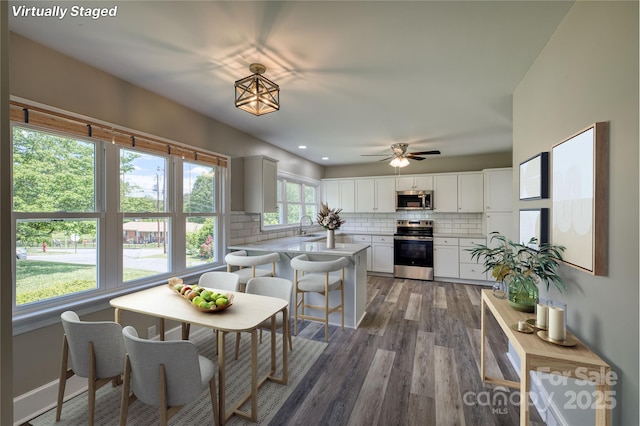 417 Mountain View Ave SE, Valdese, NC 28690 - kitchen featuring stainless steel appliances, a sink, backsplash, wood finished floors, and light countertops