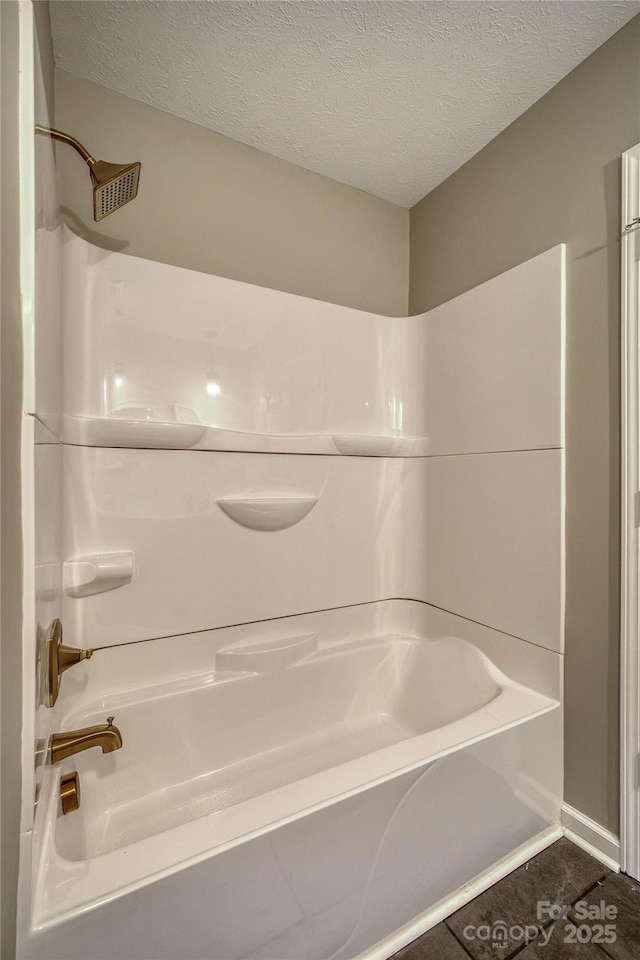 417 Mountain View Ave SE, Valdese, NC 28690 - bathroom featuring a textured ceiling and shower / washtub combination