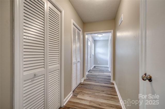 417 Mountain View Ave SE, Valdese, NC 28690 - hall featuring wood finished floors, baseboards, and a textured ceiling
