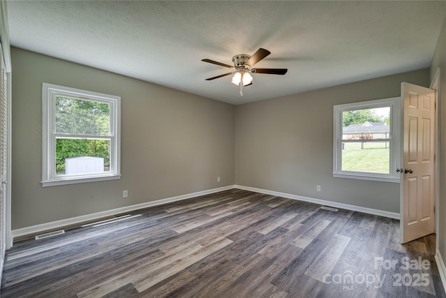 417 Mountain View Ave SE, Valdese, NC 28690 - unfurnished room featuring healthy amount of natural light, dark wood-style flooring, and ceiling fan