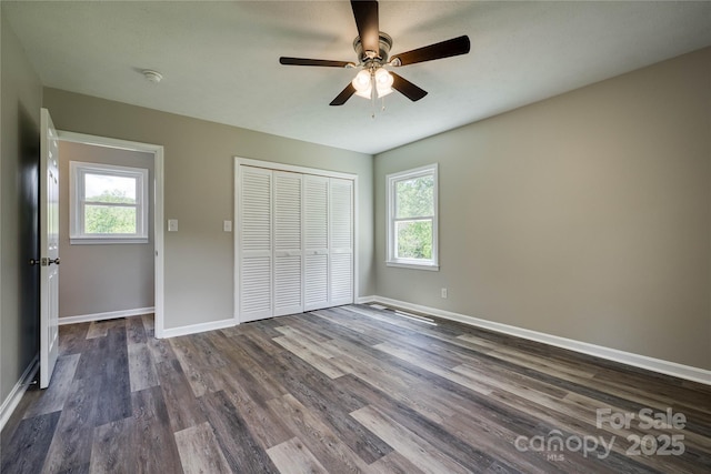 417 Mountain View Ave SE, Valdese, NC 28690 - unfurnished bedroom with multiple windows, baseboards, and dark wood finished floors