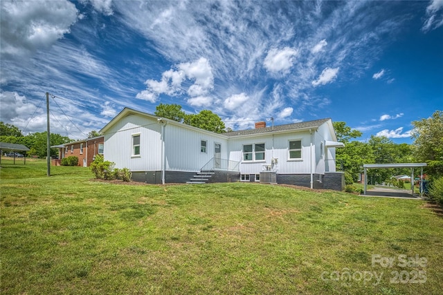 417 Mountain View Ave SE, Valdese, NC 28690 - back of house with a yard, a chimney, a detached carport, and central air condition unit