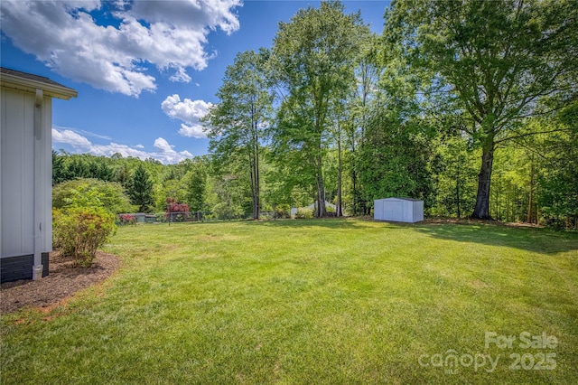 417 Mountain View Ave SE, Valdese, NC 28690 - view of grassy yard featuring a shed, an outdoor structure, and a view of trees