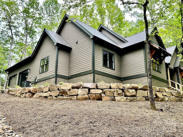 view of side of property with an attached garage and driveway
