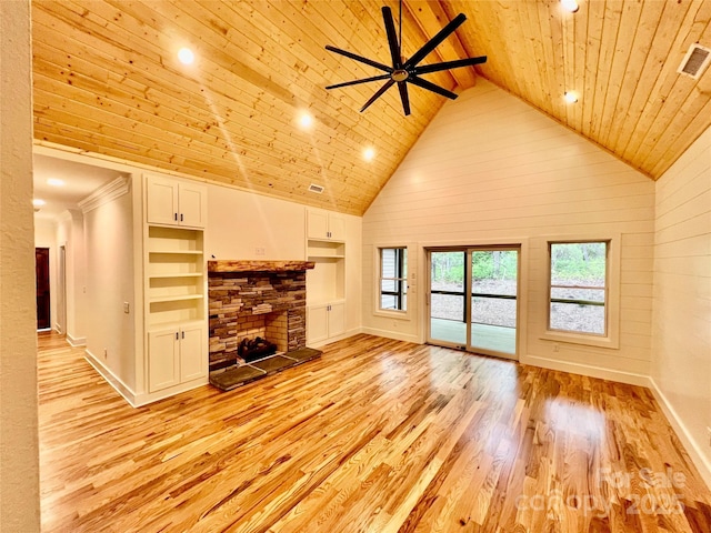 unfurnished living room with wooden ceiling, light wood-style flooring, built in shelves, a fireplace, and high vaulted ceiling