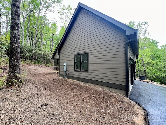 view of side of home with central air condition unit