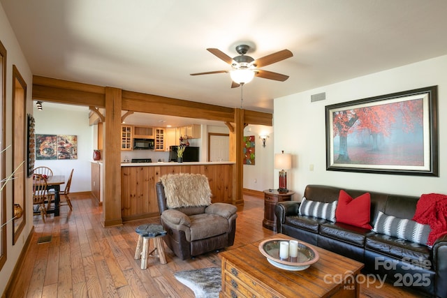 81 Creekside Way Unit F/101, Burnsville, NC 28714 - living room featuring light wood-type flooring, a ceiling fan, and baseboards