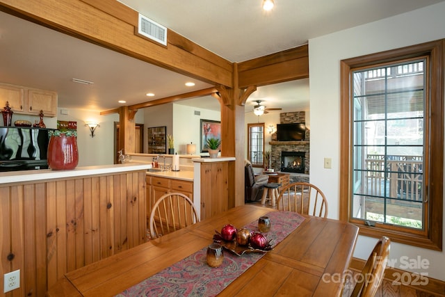 81 Creekside Way Unit F/101, Burnsville, NC 28714 - dining room featuring a stone fireplace, a ceiling fan, healthy amount of natural light, and recessed lighting