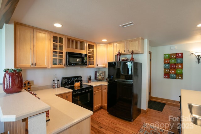 81 Creekside Way Unit F/101, Burnsville, NC 28714 - kitchen featuring black appliances, light countertops, light wood finished floors, a peninsula, and recessed lighting