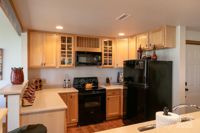 81 Creekside Way Unit F/101, Burnsville, NC 28714 - kitchen featuring black appliances, light brown cabinets, light countertops, recessed lighting, and light wood finished floors