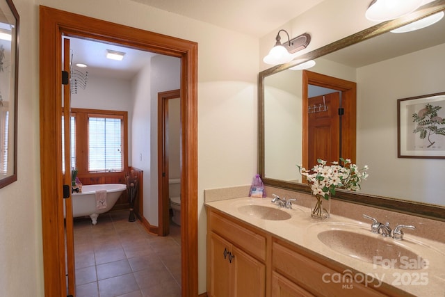 81 Creekside Way Unit F/101, Burnsville, NC 28714 - bathroom with a freestanding bath, toilet, double vanity, and tile patterned floors