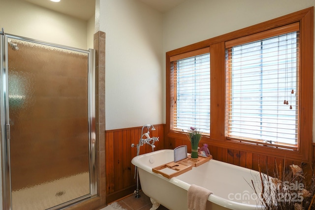 81 Creekside Way Unit F/101, Burnsville, NC 28714 - full bathroom featuring healthy amount of natural light, a shower stall, a wainscoted wall, a soaking tub, and wood walls