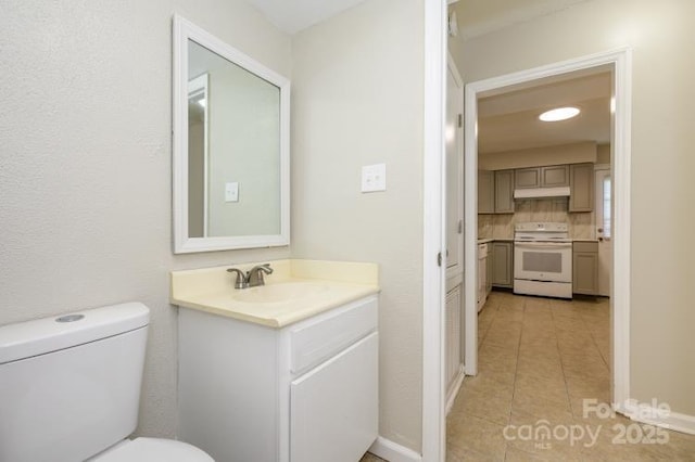 bathroom with tile patterned flooring, toilet, and vanity
