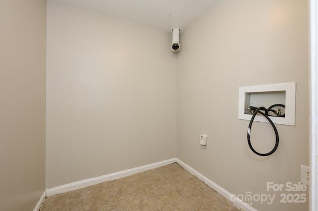 washroom featuring baseboards and washer hookup