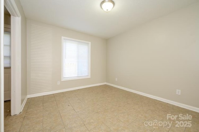 spare room featuring baseboards