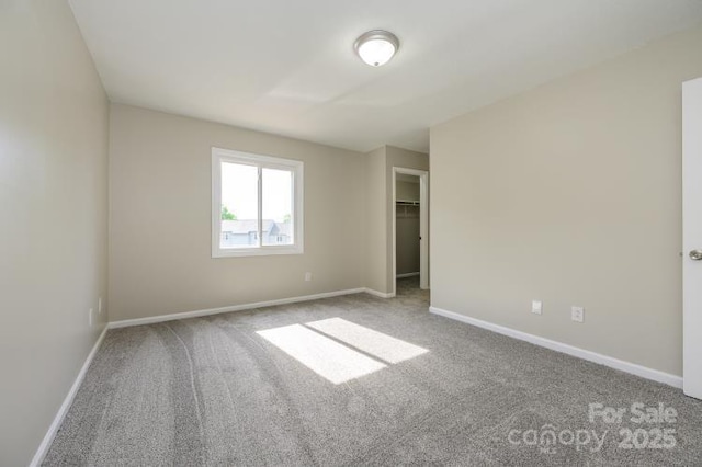 unfurnished bedroom featuring carpet flooring and baseboards
