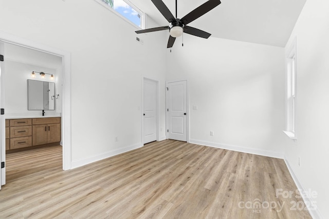 424 Airline Ave, Shelby, NC 28150 - unfurnished bedroom with high vaulted ceiling, light wood finished floors, baseboards, connected bathroom, and ceiling fan