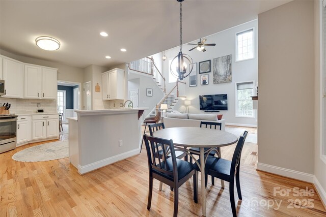 dining area with healthy amount of natural light, baseboards, ceiling fan, light wood-style flooring, and recessed lighting
