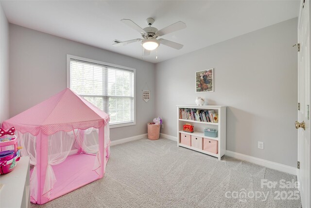 game room featuring baseboards, ceiling fan, and carpet