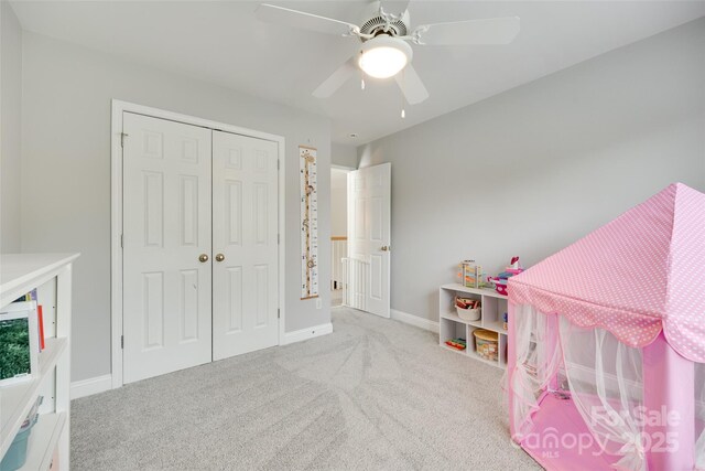 recreation room featuring carpet, ceiling fan, and baseboards