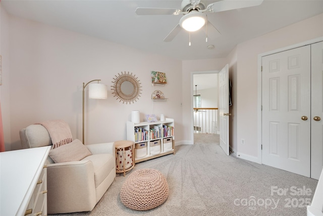 sitting room with carpet, ceiling fan, and baseboards