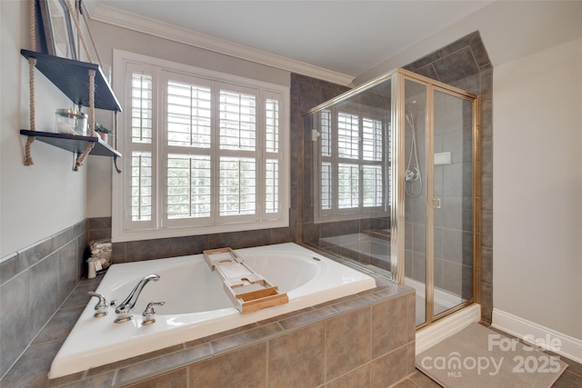 bathroom featuring a stall shower, a garden tub, and crown molding