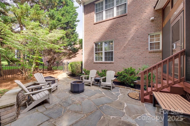 view of patio with fence and an outdoor fire pit