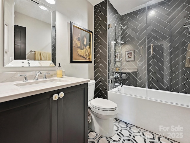 full bathroom featuring toilet, enclosed tub / shower combo, and vanity