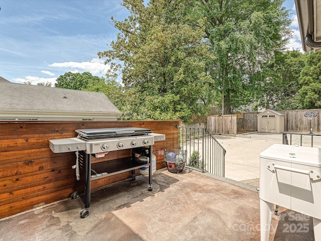 view of patio / terrace featuring a storage shed, a fenced backyard, and an outdoor structure