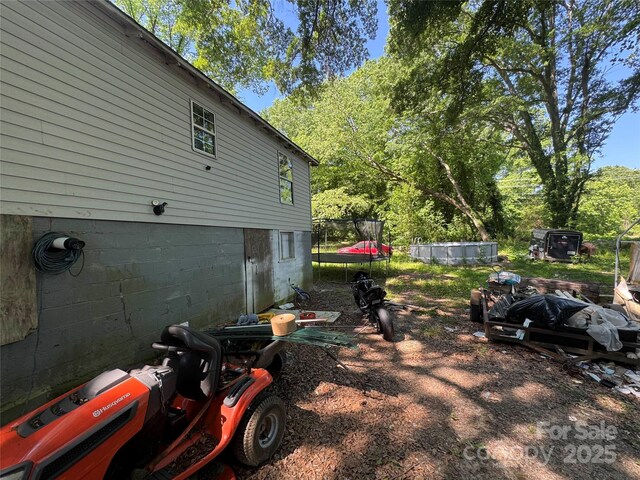 view of side of property featuring a trampoline