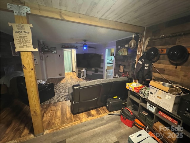living area with wood finished floors, beamed ceiling, and wood ceiling