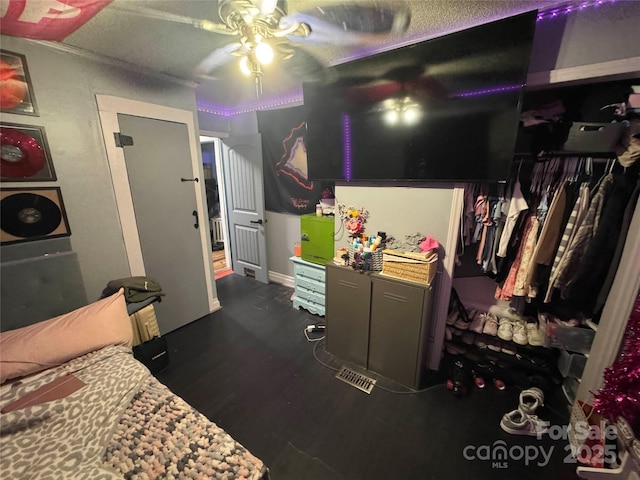 bedroom with wood finished floors and a closet