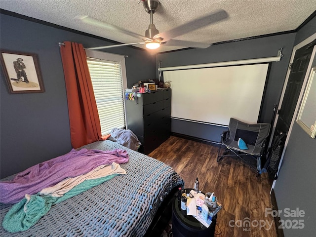 bedroom featuring wood finished floors, a textured ceiling, and ceiling fan