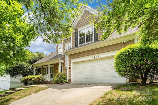 6434 Skyline Dr, Charlotte, NC 28269 - traditional-style house with driveway, a porch, an attached garage, and roof with shingles