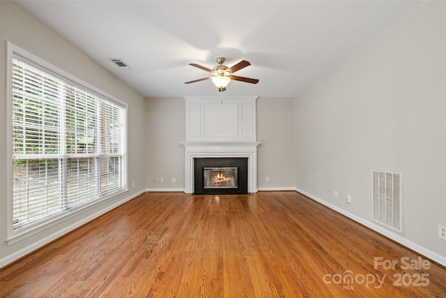 6434 Skyline Dr, Charlotte, NC 28269 - unfurnished living room featuring a fireplace, ceiling fan, wood finished floors, and baseboards