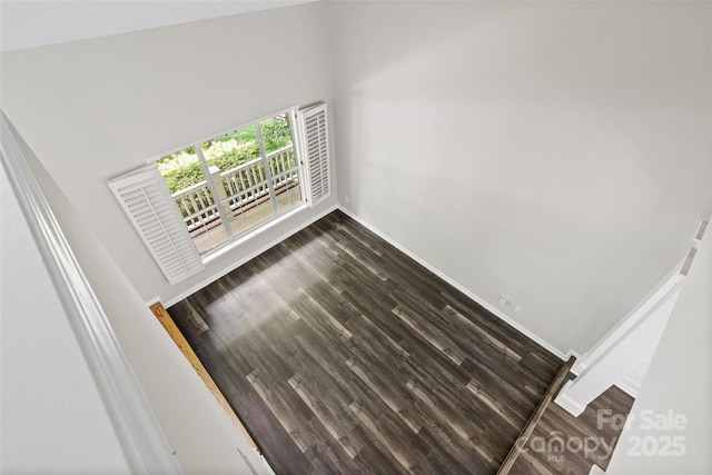 6434 Skyline Dr, Charlotte, NC 28269 - unfurnished living room featuring baseboards and dark wood-type flooring