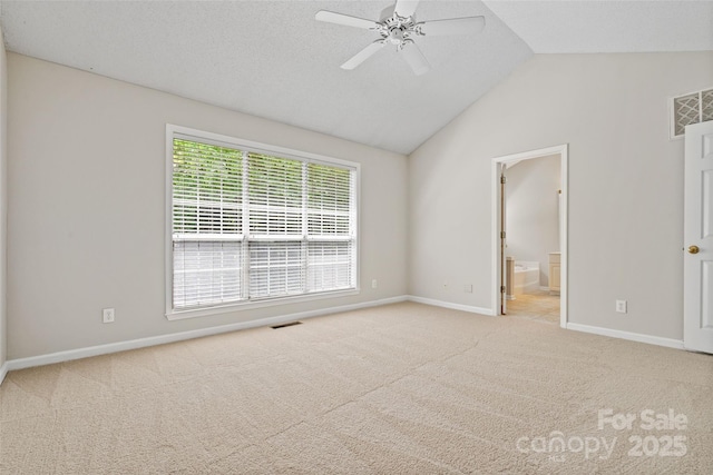 6434 Skyline Dr, Charlotte, NC 28269 - unfurnished bedroom featuring lofted ceiling, carpet flooring, baseboards, connected bathroom, and ceiling fan